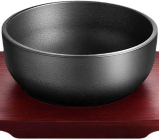 Cast iron dolsot bibimbap bowl with wooden base, 31 oz heat-retaining design for rice and stews.